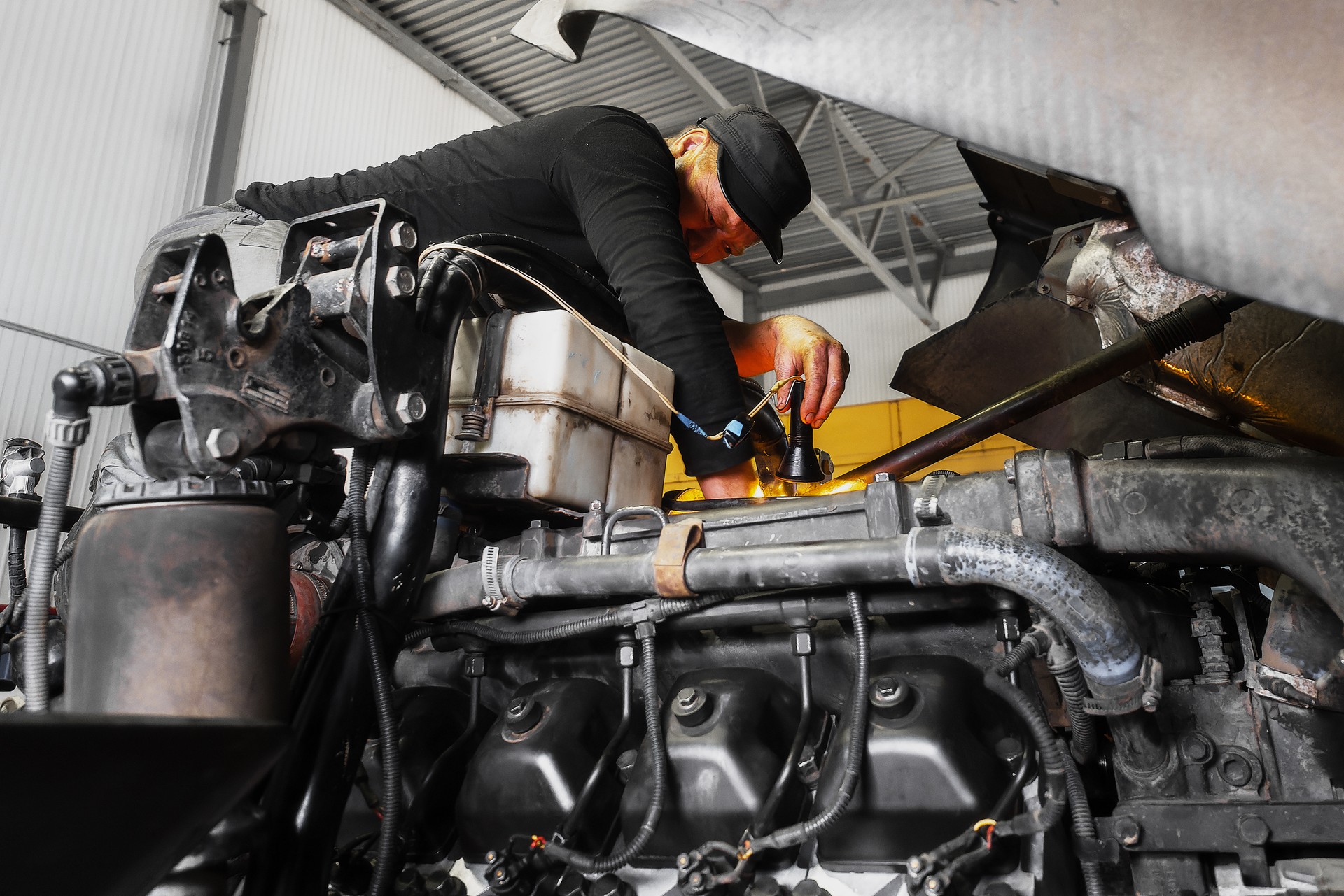 Roadside mechanic repairs truck engine on florida turnpike