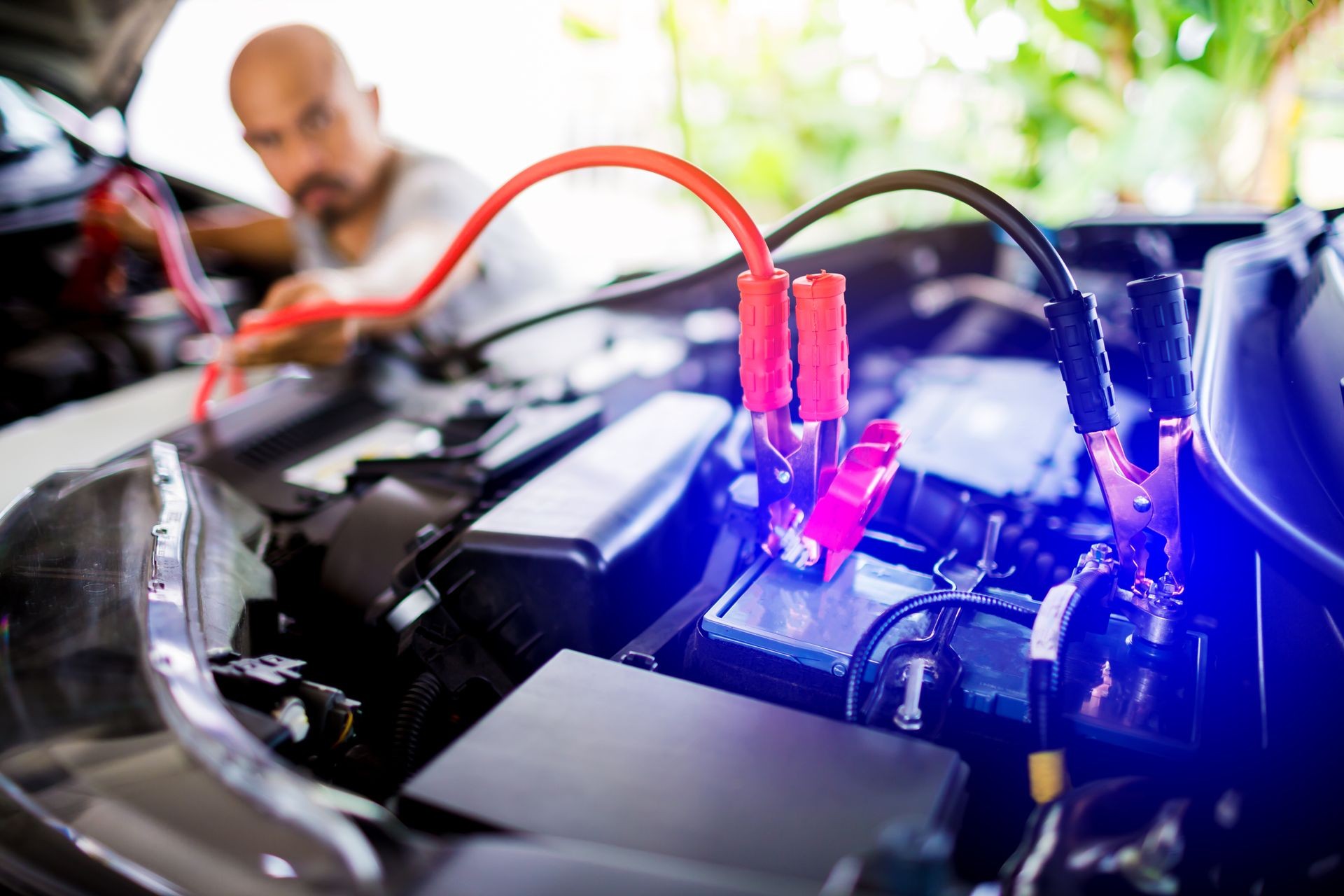 mechanic jump starting car battery, mechanic engineer fixing car battery with delivery service on road or home, the concepts of car maintenance services in every location